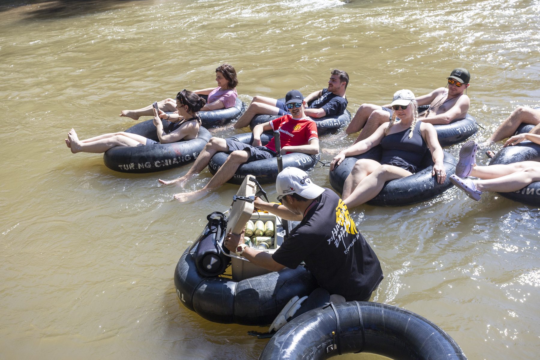 Group river tubing down the Mae Taeng with a guide