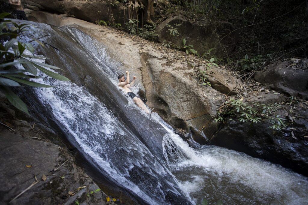 A guest riding the SaGee waterfall rock slide