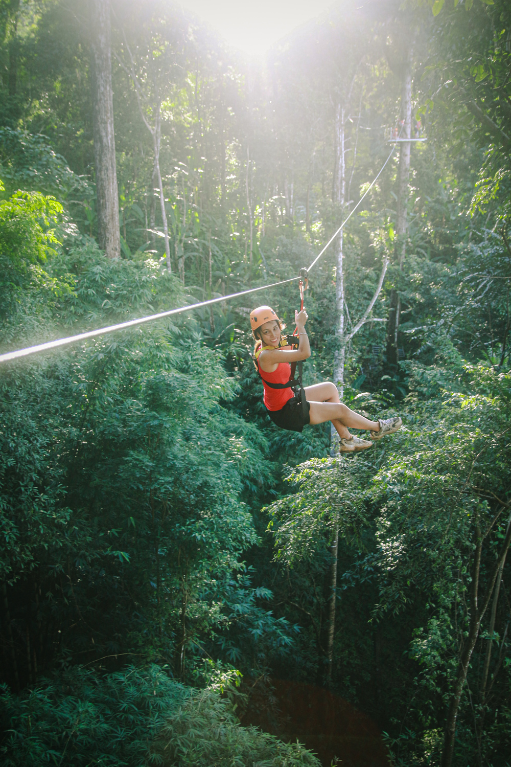 Guest smiling on a jungle zipline in Chiang Mai