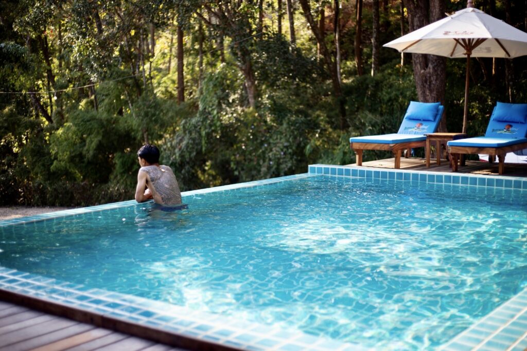 Guest swimming in the pool beside the jungle