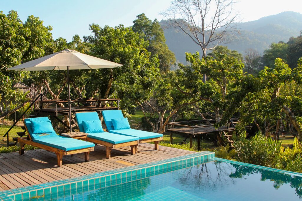 Sun loungers by the infinity pool with valley views