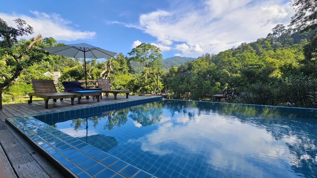 Infinity pool reflecting the mountains and sky