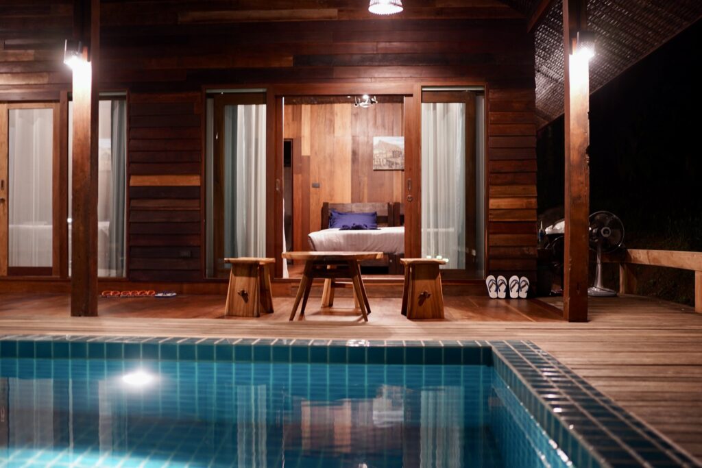Poolside Villa at night with the pool lit up