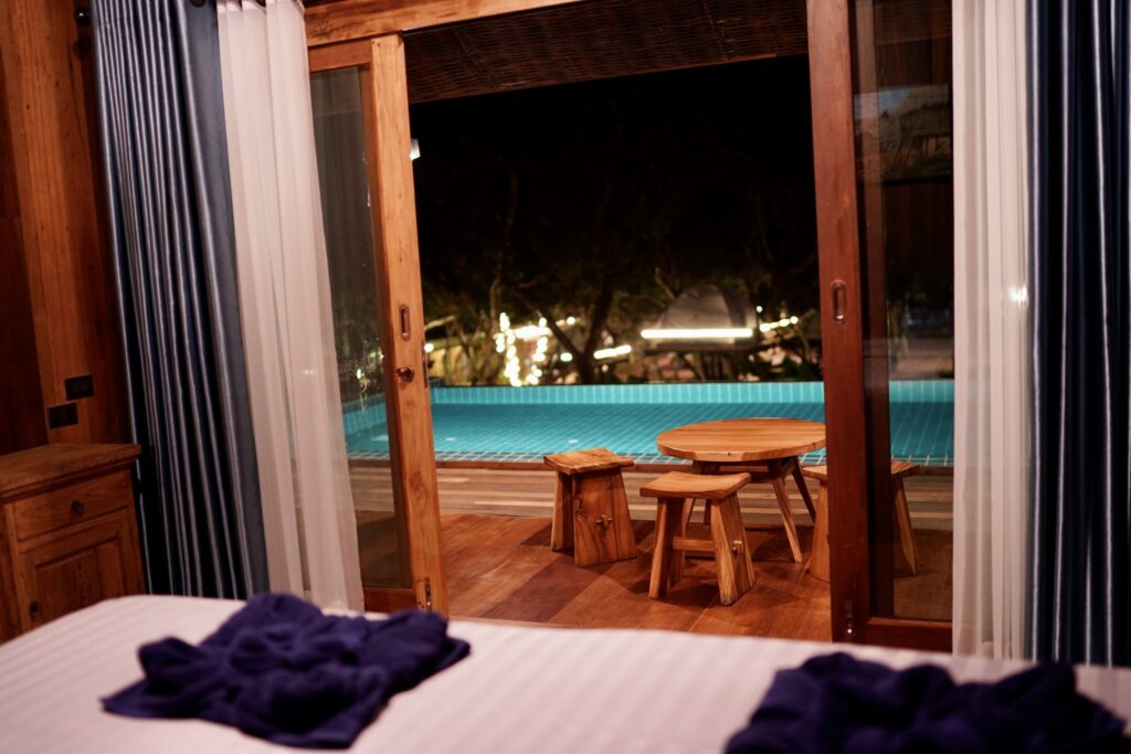 View from the Poolside Villa bed out to the lit pool at night