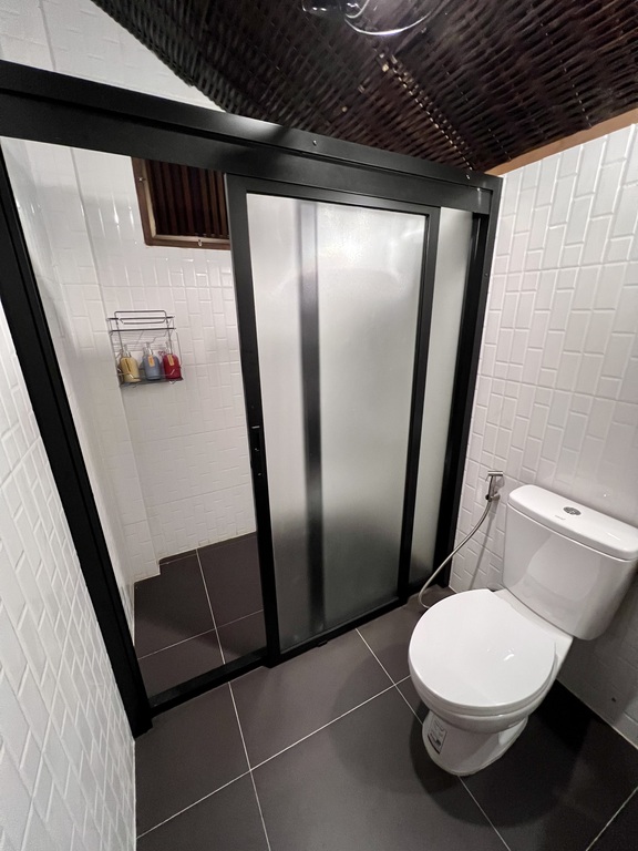 Private villa bathroom with glass hot-water shower