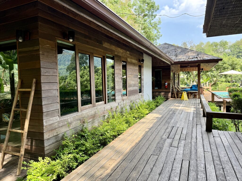 Wooden villa exterior along the pool deck