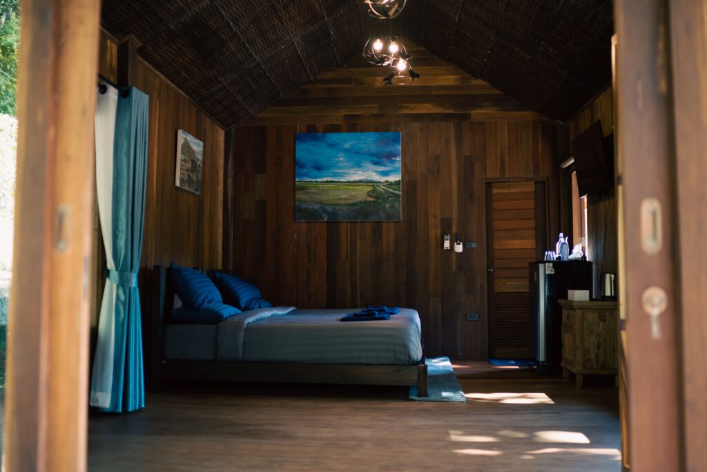 Wooden villa living space with sofa and king bed