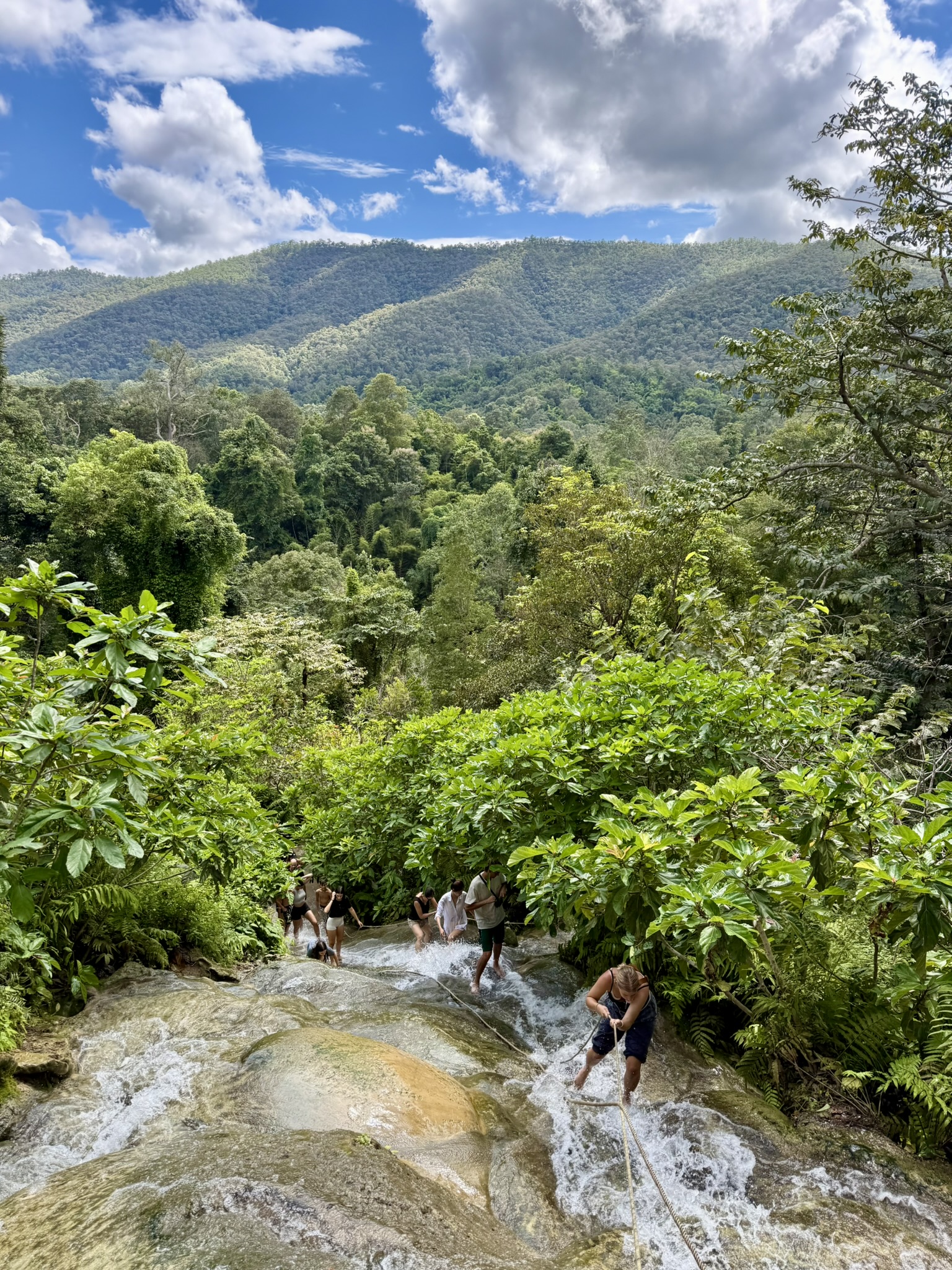 Looking down Bua Tong Sticky Waterfall over the forested hills north of Chiang Mai