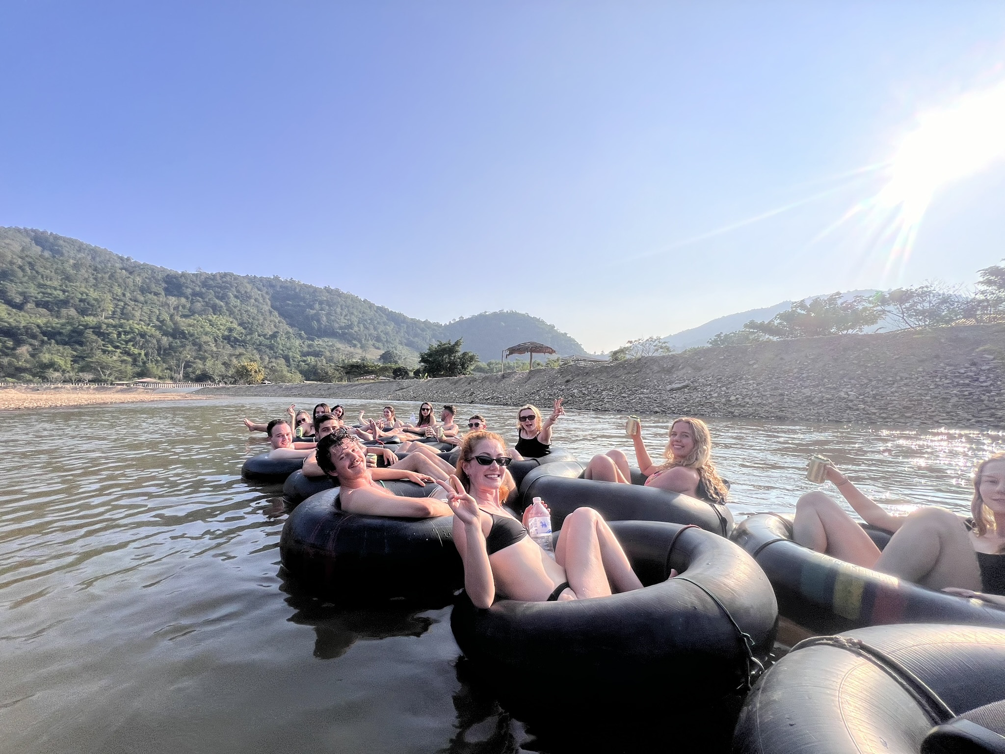 The whole group tied into one long raft of tubes on the Mae Taeng with the mountains behind