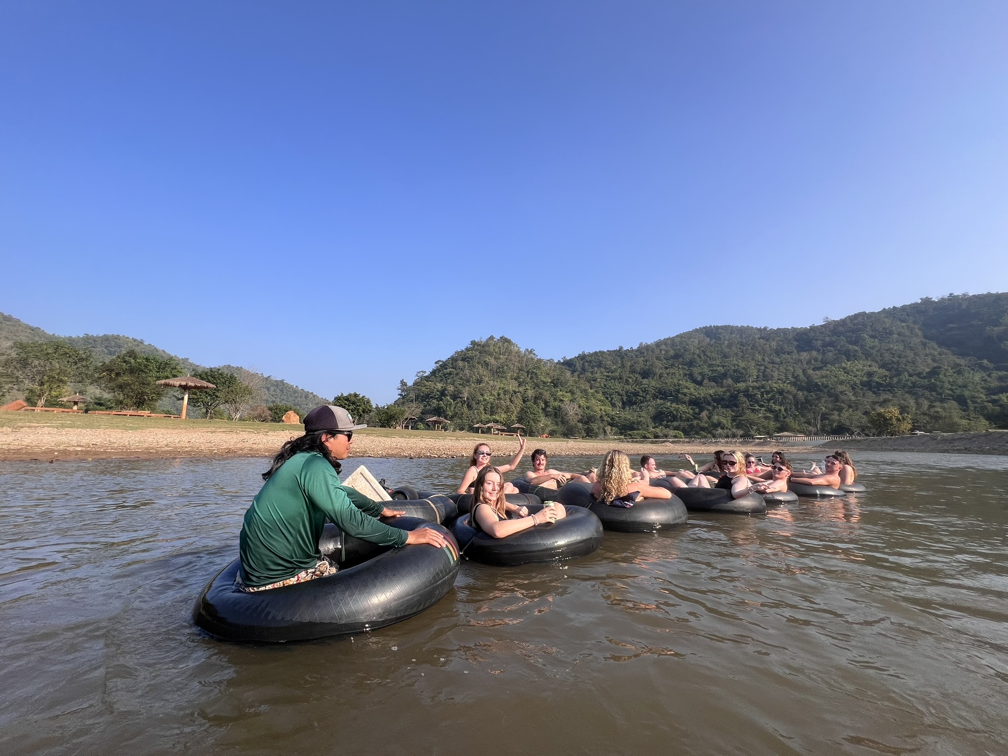 A Tubing Chiang Mai guide floating alongside the group on the late afternoon river