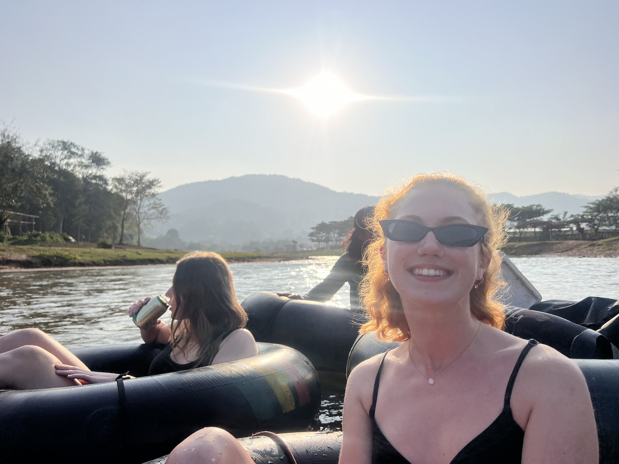 The low afternoon sun behind the hills above the Mae Taeng river on the sunset float