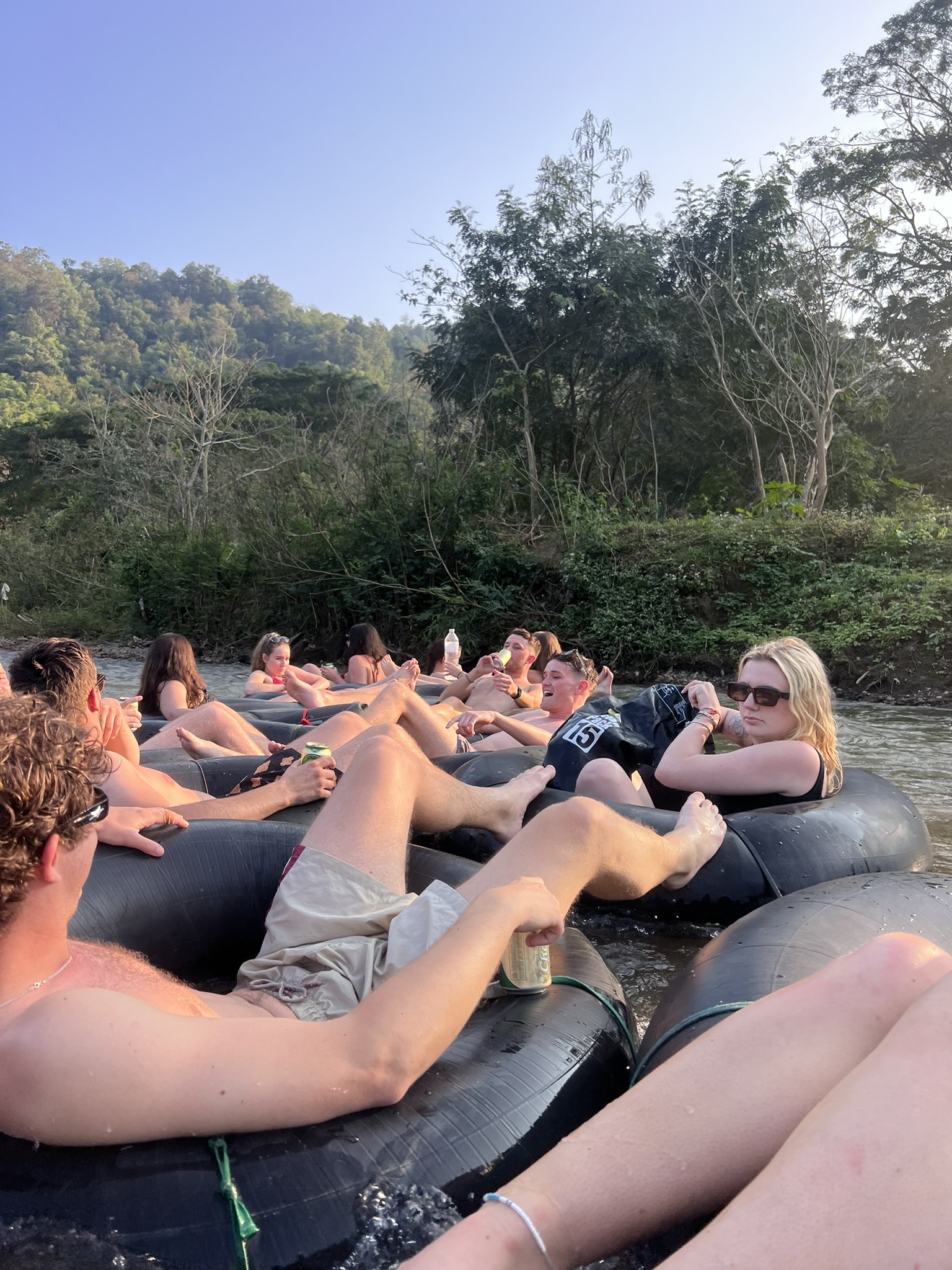 Guests lying back in their tubes as the raft drifts down the Mae Taeng